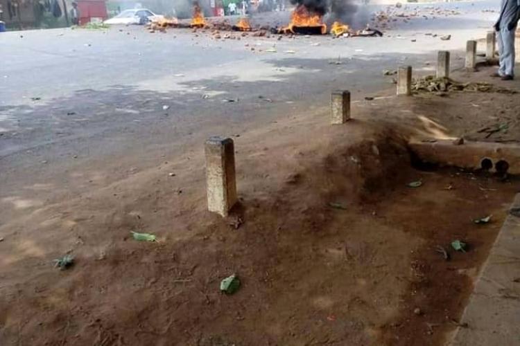 The M1-road at Nsipe Trading Centre which was blocked with burning tyres and tree logs by some angry Kabaza operators. 