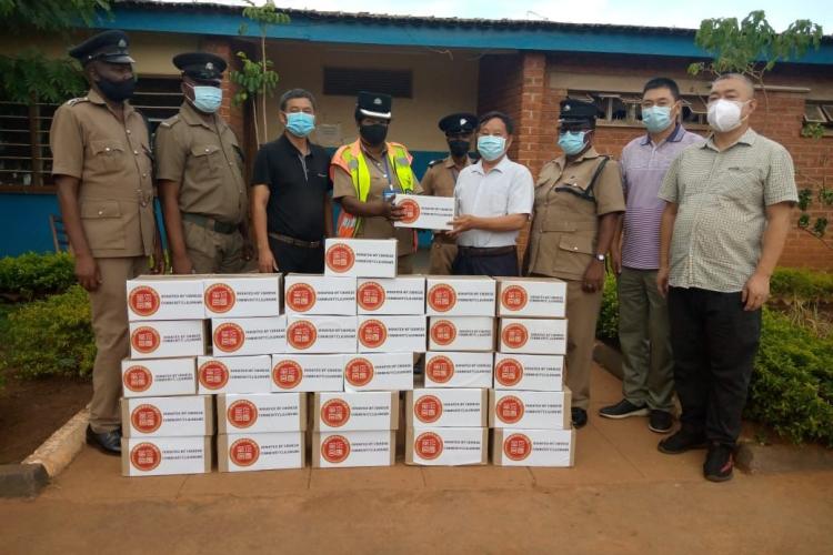 Representatives of the Chinese business community handing over assorted items to Lumbadzi Police