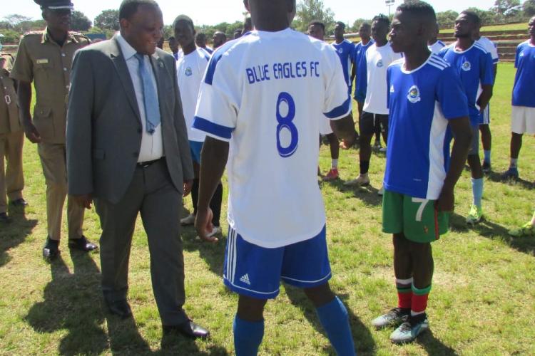 The Inspector General of Police, Dr. George Kainja PPM (in grey suit), shares a light moment with Blue Eagles Chairman, Superintendent Alexander Ngwala 