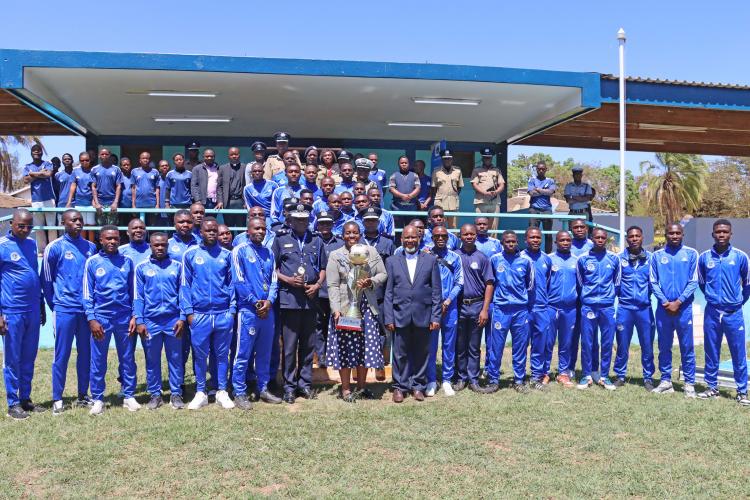 Group photo of Blue Eagles players and the Inspector General of Police